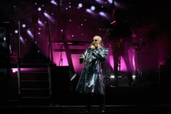 Neil Tennant of Pet Shop Boys performs in a silver metallic raincoat and sunglasses at Budweiser Stage in Toronto, CANADA