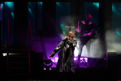 Neil Tennant of Pet Shop Boys performs in a silver metallic raincoat in front of a percussionist at Budweiser Stage in Toronto, CANADA