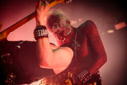 Yves Tumor (right) playing around with guitarist Chris Geratti, covering his face with a towel and pulling him backwards